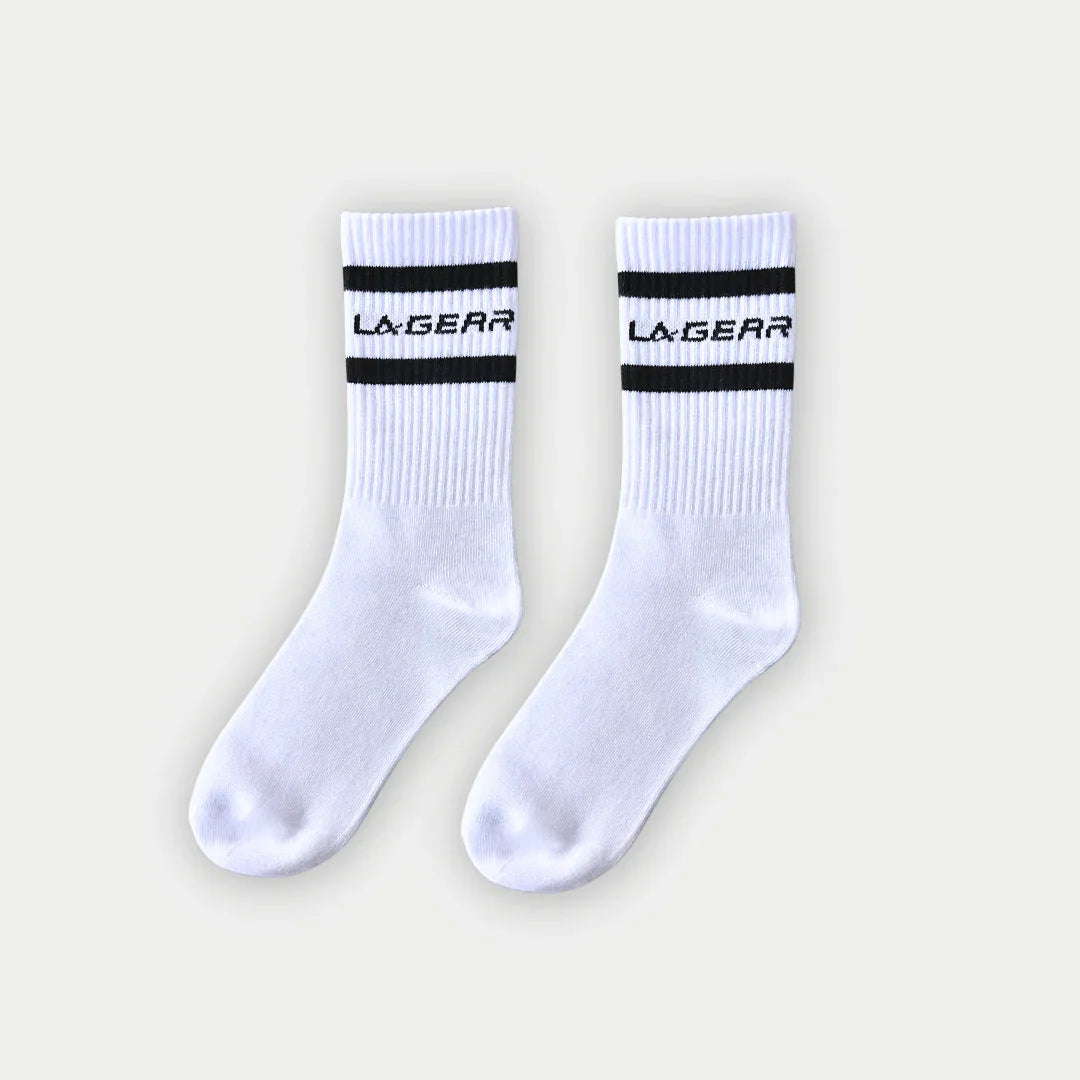 White socks with black stripes and 'La Gear' branding on a light gray background
