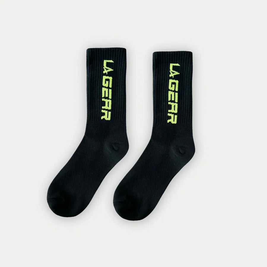 Black socks with neon yellow 'LA Gear' logo on a white background