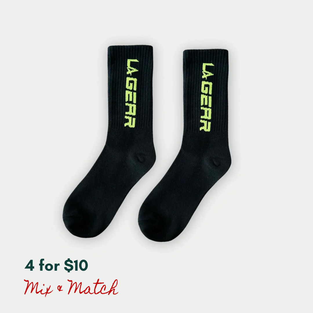 Black socks with neon yellow 'LA Gear' logo on a white background