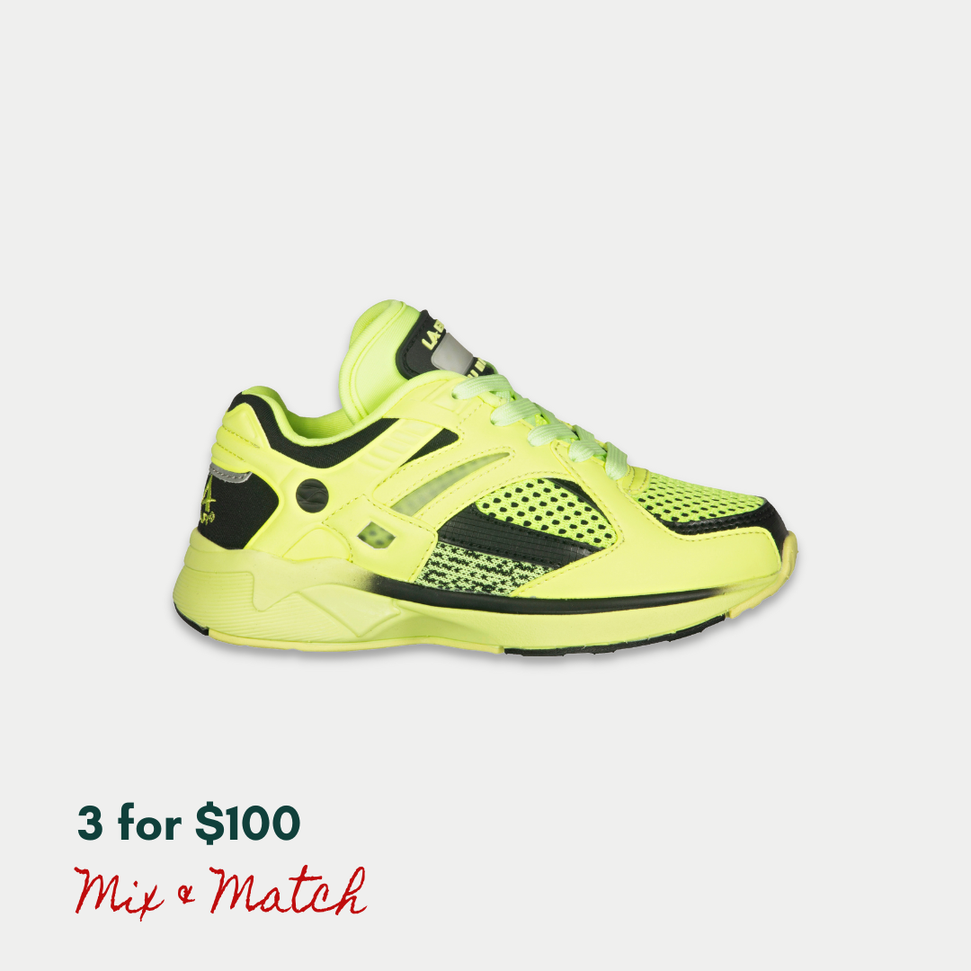 Neon yellow and black kids LA Gear sneaker with motion activated lights on a light gray background.