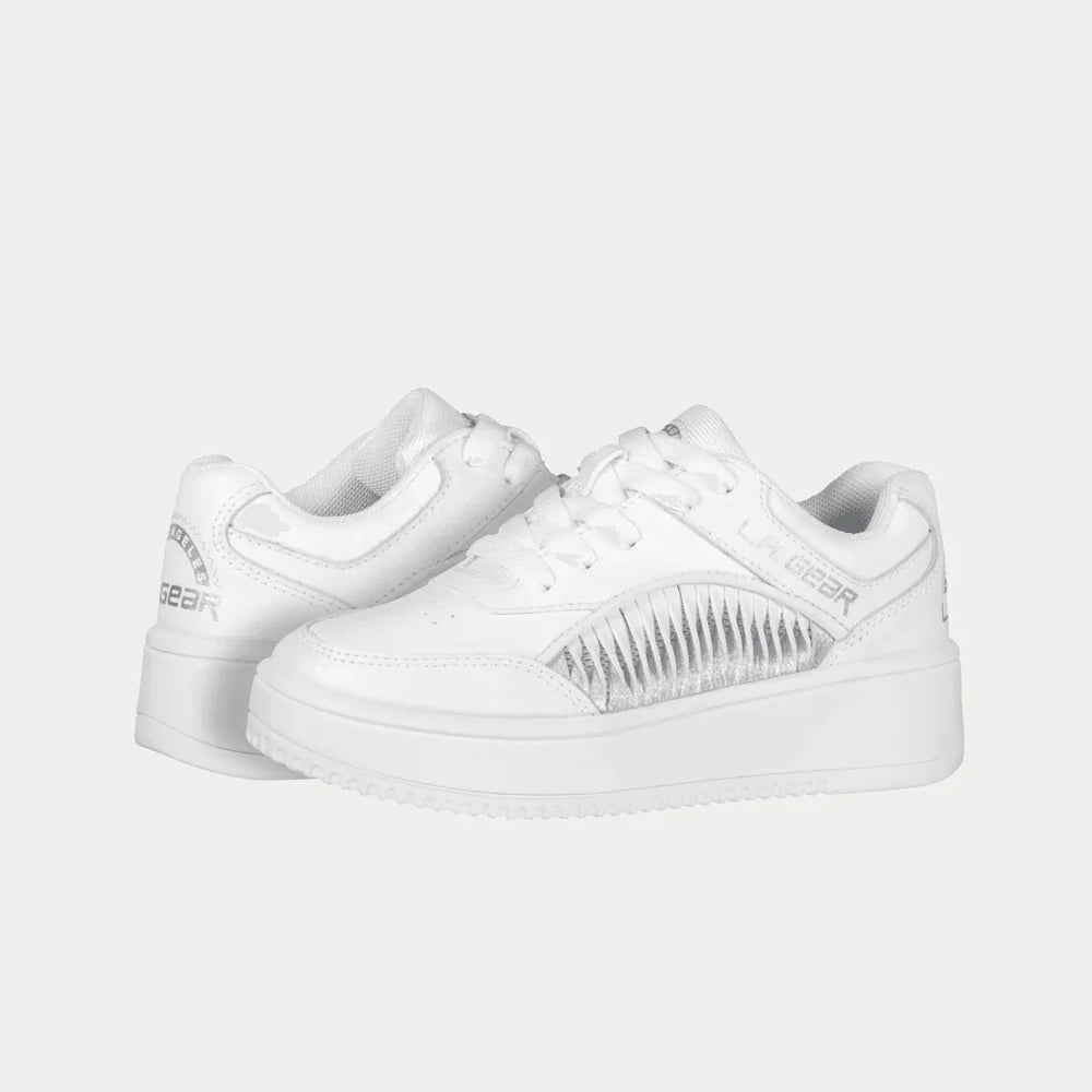 White lowtop sneakers with LA Gear logo on a light gray background