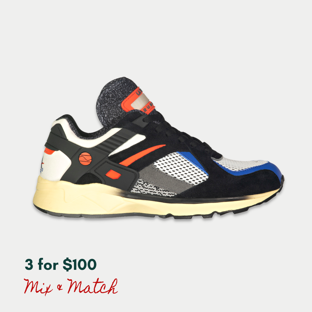 Black and orange LA Gear sneaker on a light gray background, with a light-up rechargeable tongue.