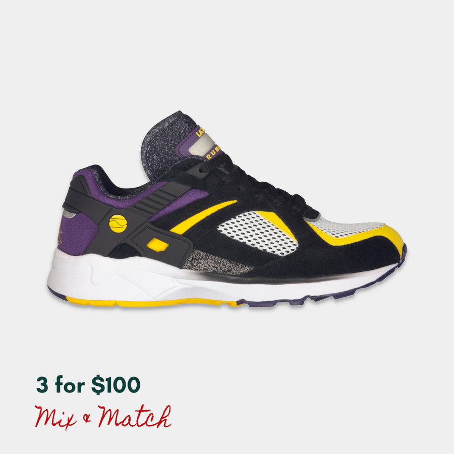 Black, purple, and yellow LA Gear sneaker with a rechargeable light-up tongue on a light gray background