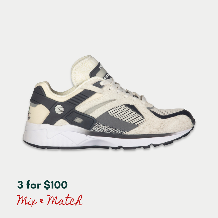 White and black LA Gear sneaker on a light gray background, with a light-up rechargeable tongue.