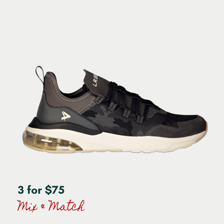 Black sneaker with a visible air cushion on a light gray background