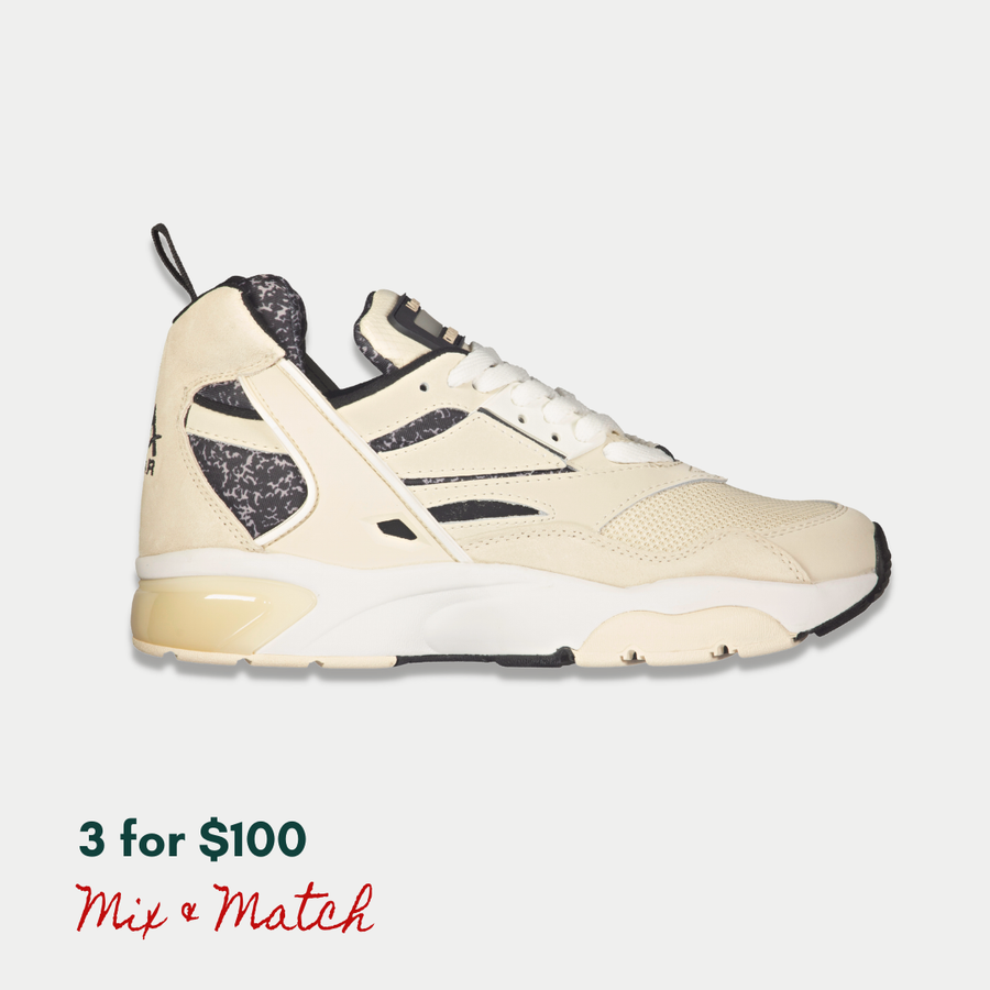 Off-white and black mid LA Gear sneaker with a light-up, rechargeable tongue.