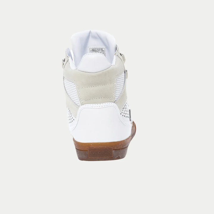 White sneaker with beige accents on a white background