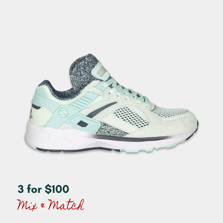 Mint and black LA Gear sneaker with a rechargeable light-up tongue on a light gray background