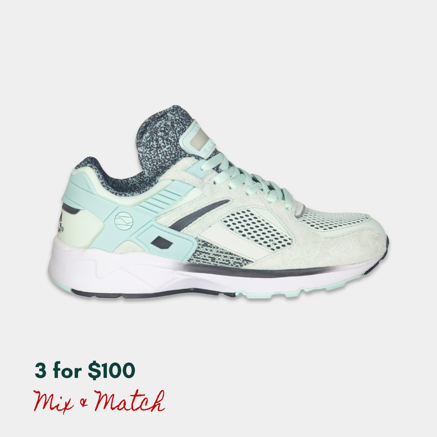 Mint and black LA Gear sneaker with a rechargeable light-up tongue on a light gray background