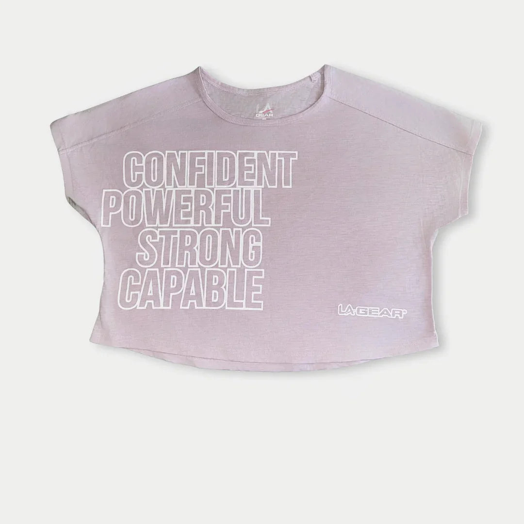 Lavender-pink capped sleeve top with motivational text on a white background