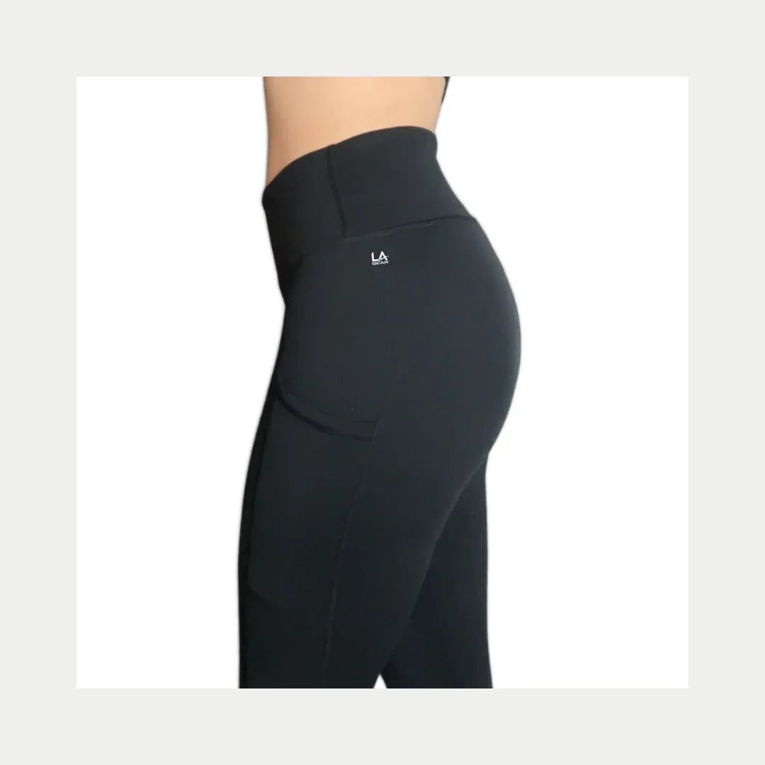 Black athletic yoga pants with a logo on a white background