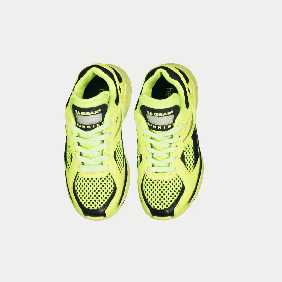 Pair of neon yellow lowtop shoes with black accents on a light gray background