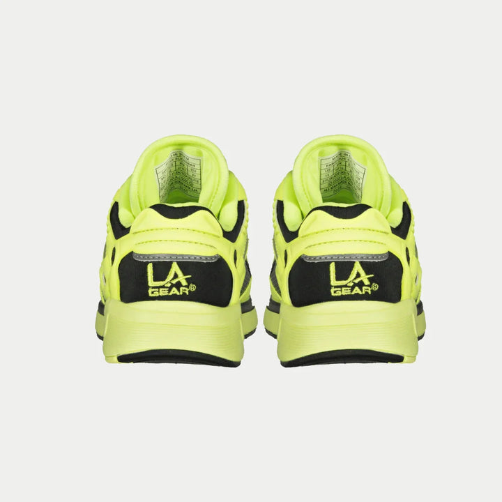 Pair of neon yellow lowtop shoes with 'LA Gear' logo on a white background