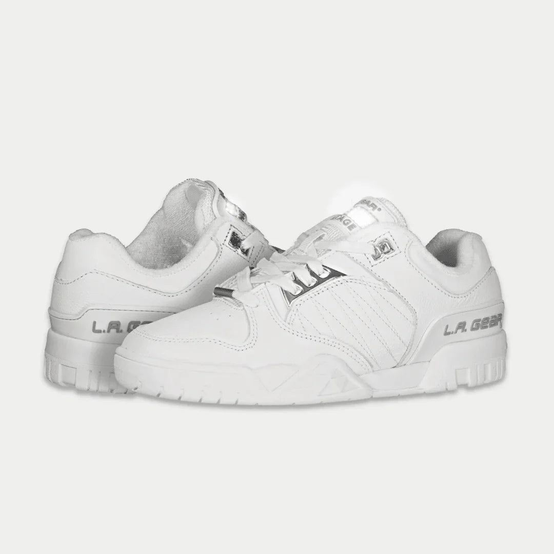 White sneakers with brand logo on a light gray background