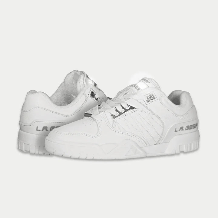White sneakers with brand logo on a light gray background