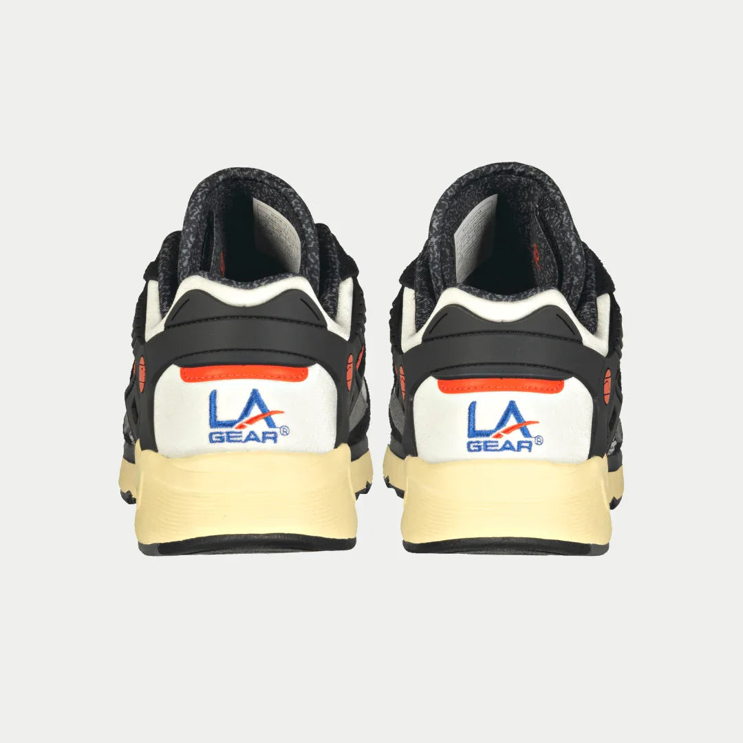 Back view of black and orange  LA Gear sneakers on a light gray background