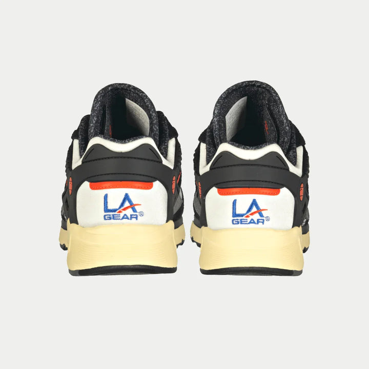 Back view of black and orange  LA Gear sneakers on a light gray background
