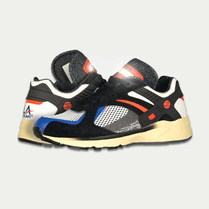 Black and orange sneakers with colorful accents on a light gray background