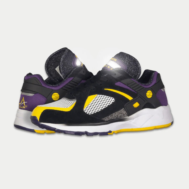 Black, purple, and yellow sneaker on a light gray background