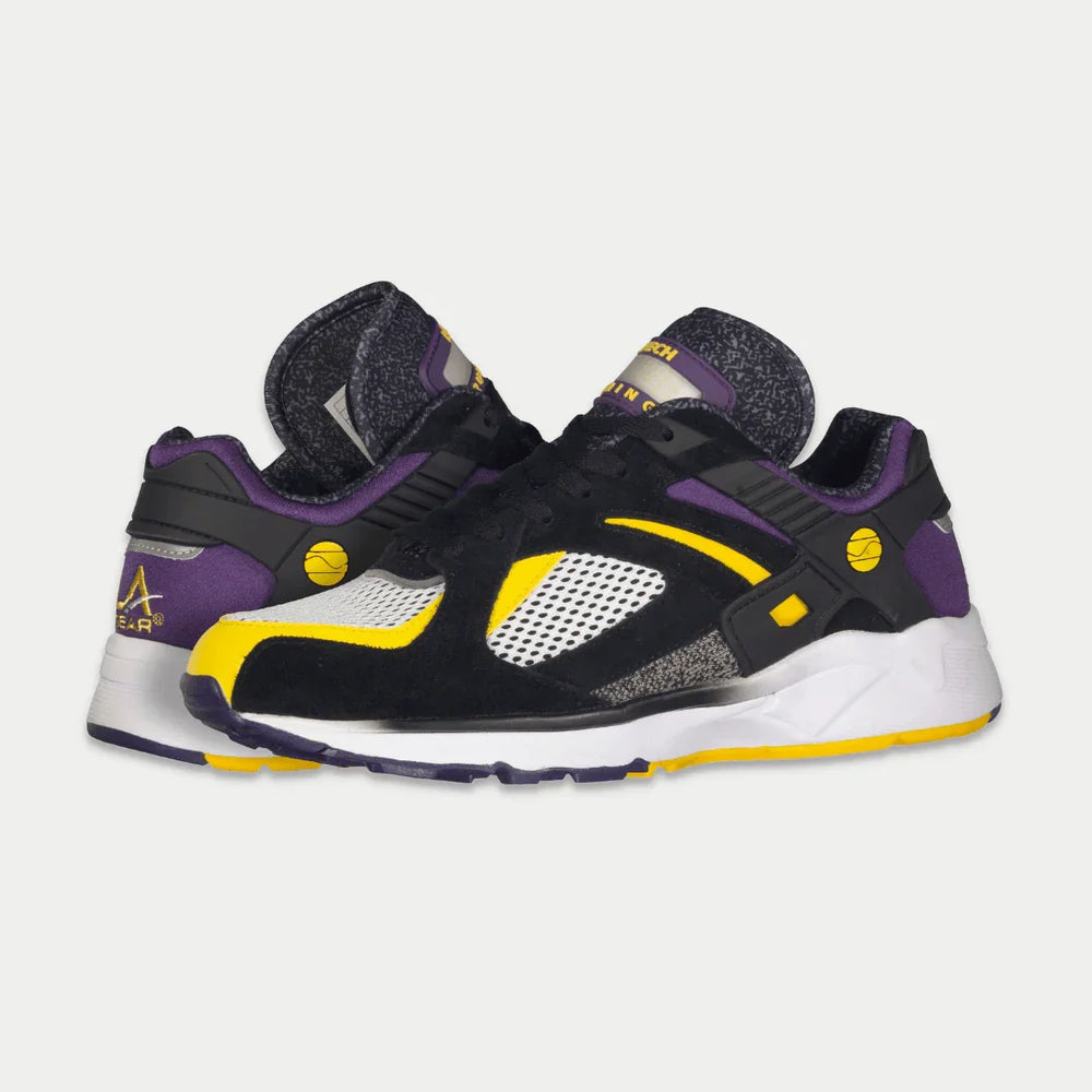 Black, purple, and yellow sneakers on a white background