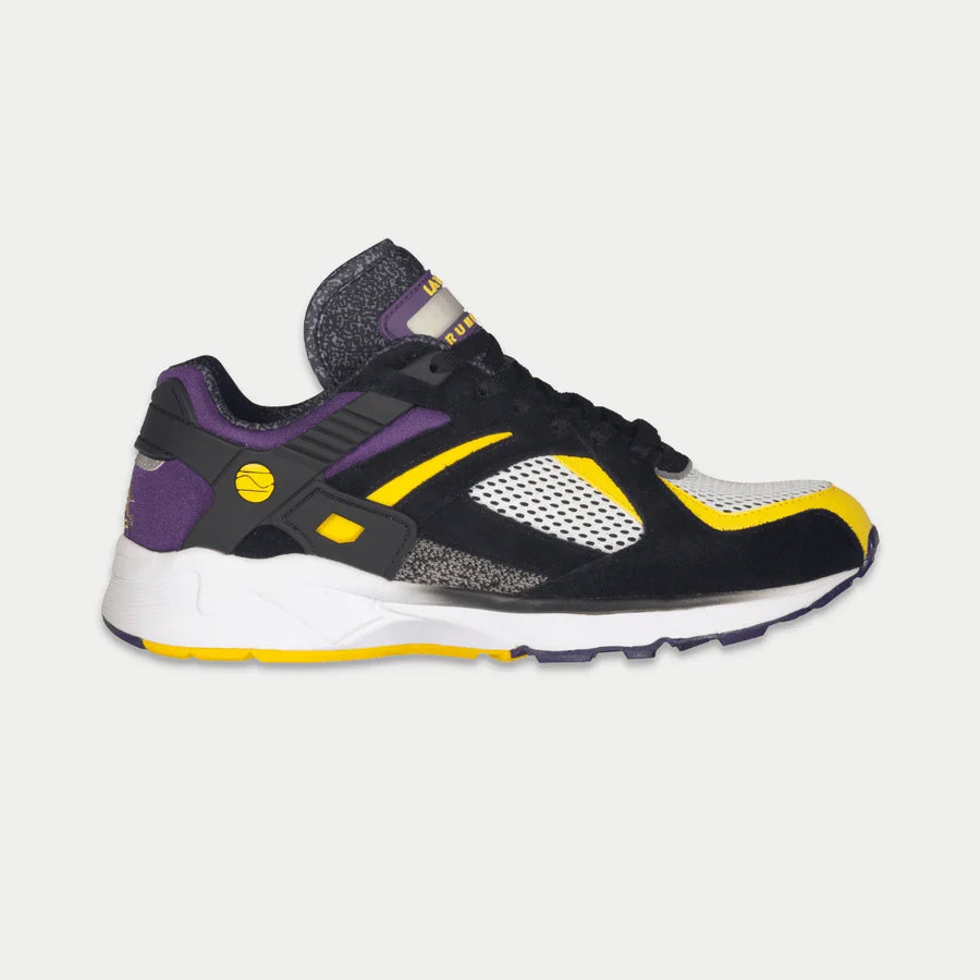 Black, purple, and yellow sneaker on a light gray background