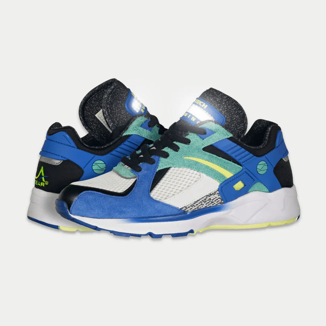 Colorful sneakers with blue x green design on a light gray background