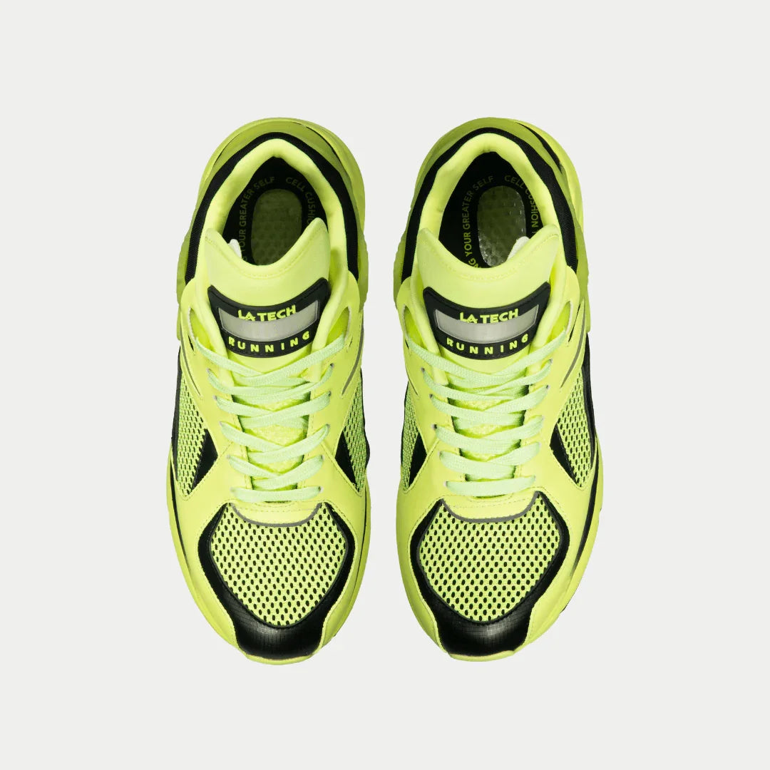 Pair of neon yellow running shoes with black accents on a light gray background