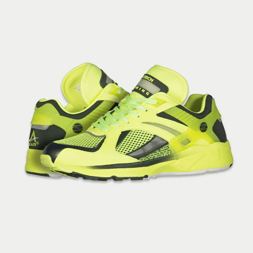 Neon yellow x black  shoes with black accents on a light gray background