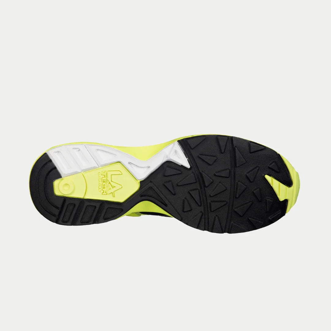 Sole of a sneaker with black, white, and yellow colors on a light gray background