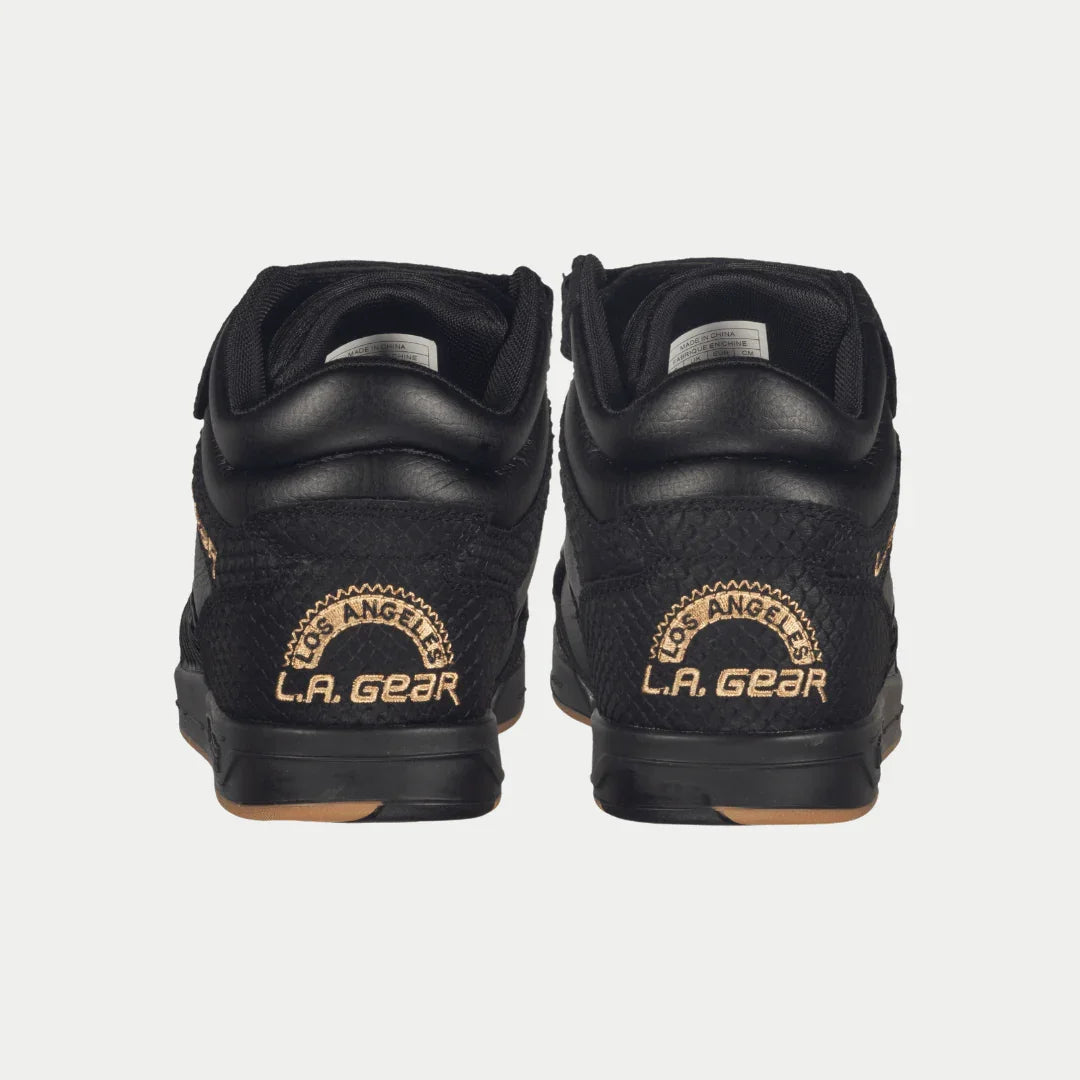 Black sneakers with 'LA Gear' logo on a white background