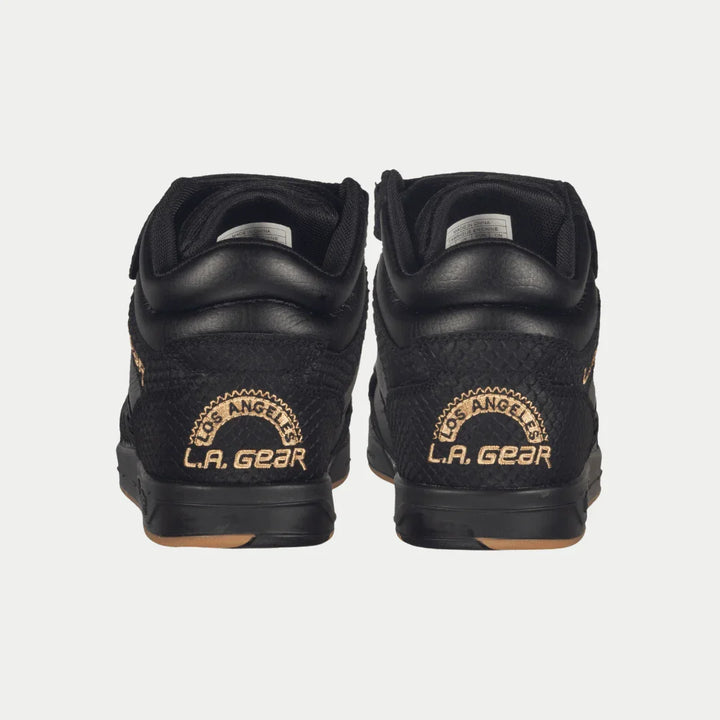 Black sneakers with 'LA Gear' logo on a white background