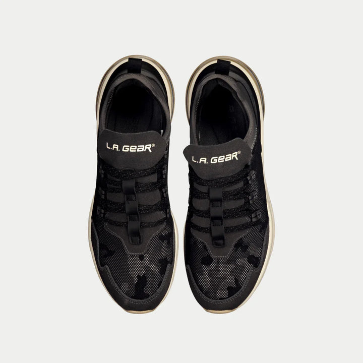 Black sneakers with 'L.A. Gear' branding on a white background