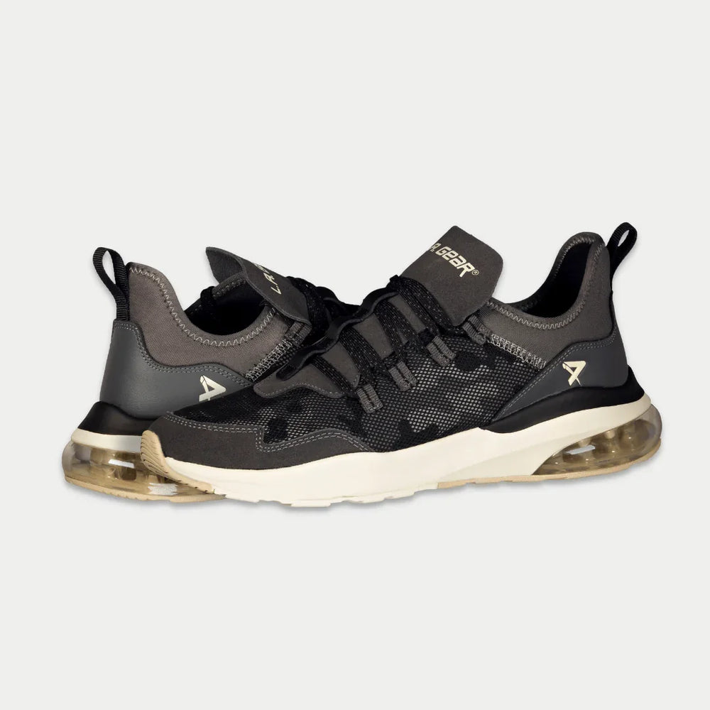 Black and gray sneakers with a brand logo on a light gray background