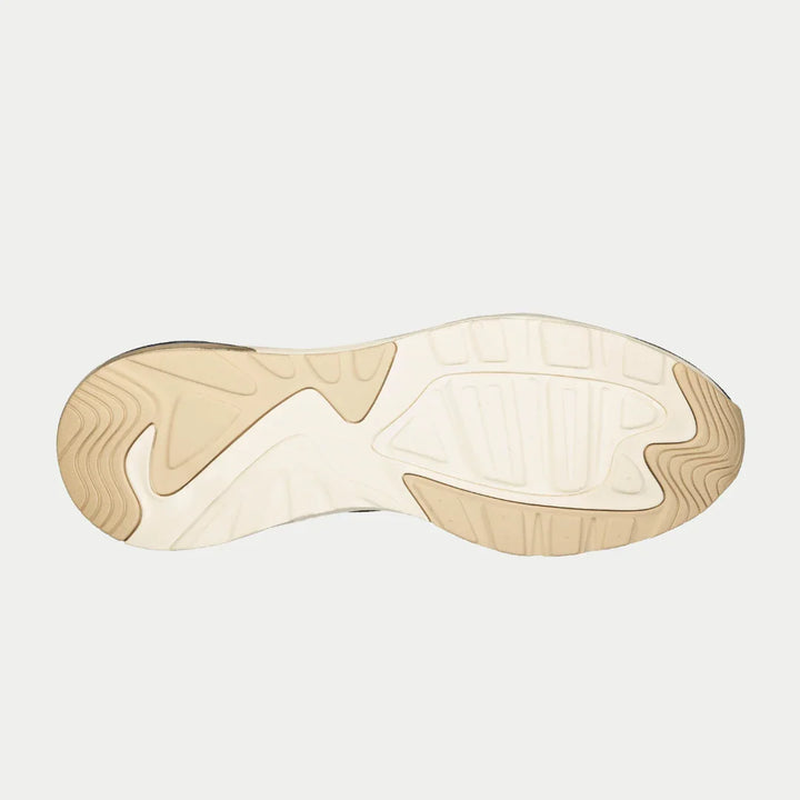 Close-up of a shoe sole with a neutral color palette on a light gray background