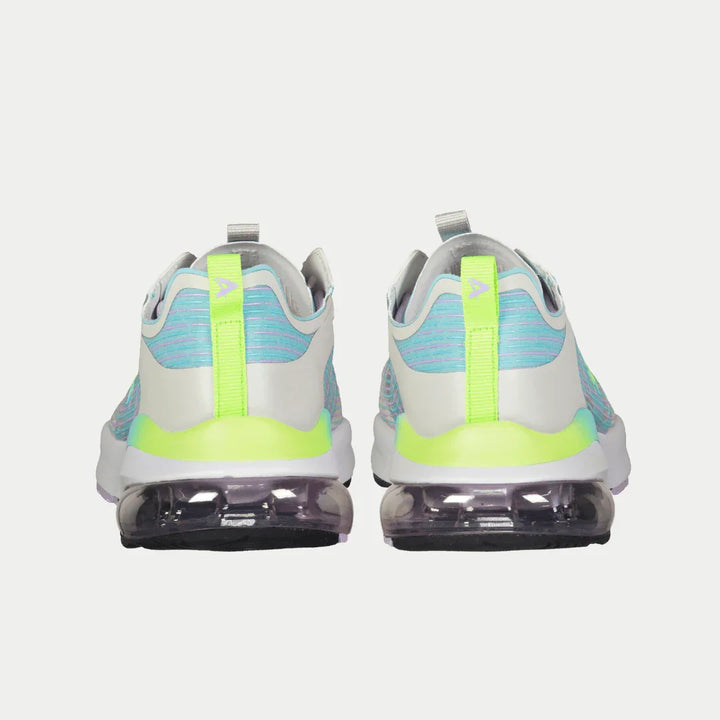 Pair of sneakers with green accents on a white background