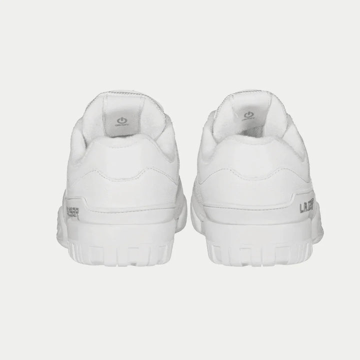 Pair of white sneakers on a light gray background