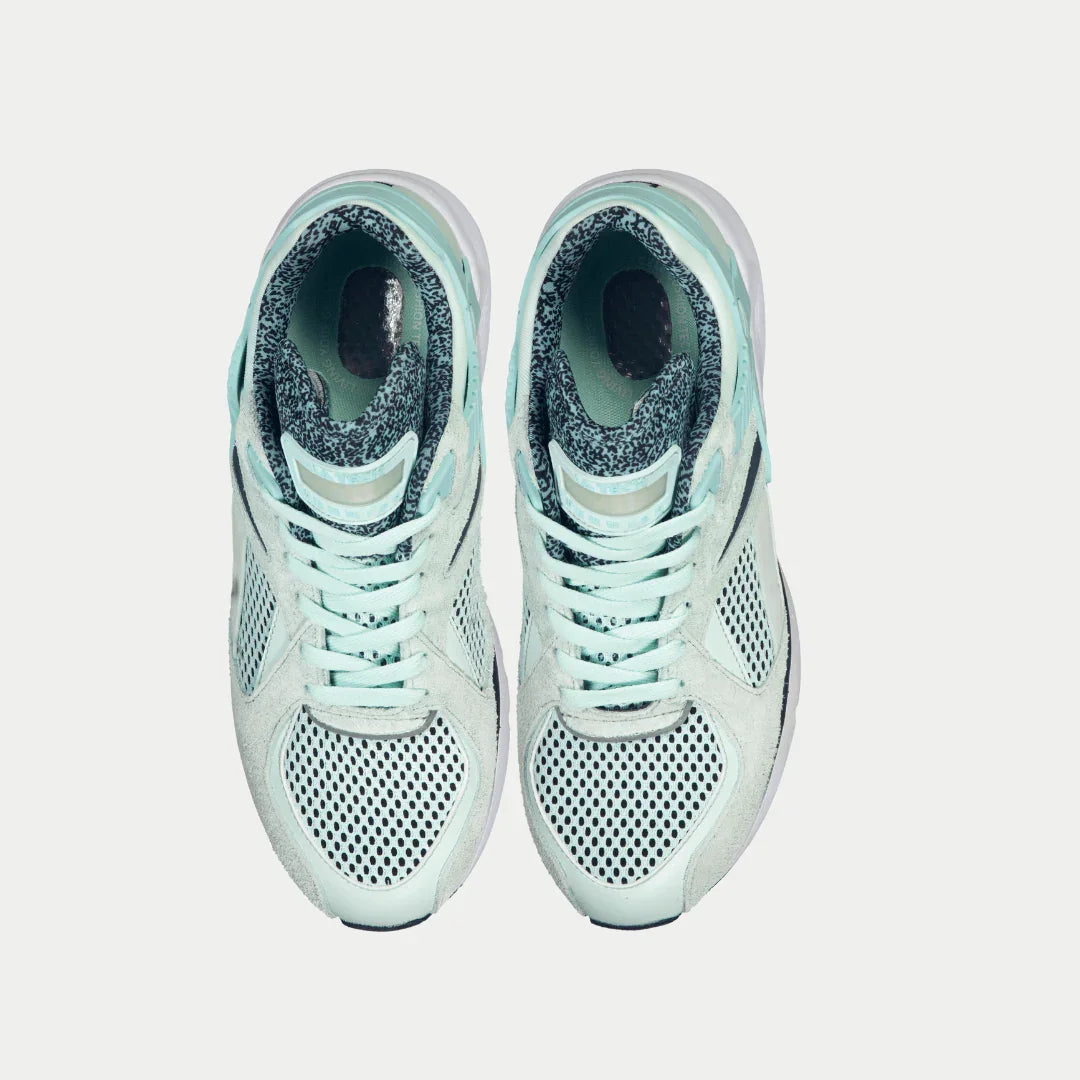 Pair of mint x black sneakers on a white background