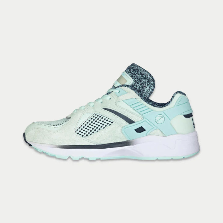 Mint x black sneaker on a light gray background