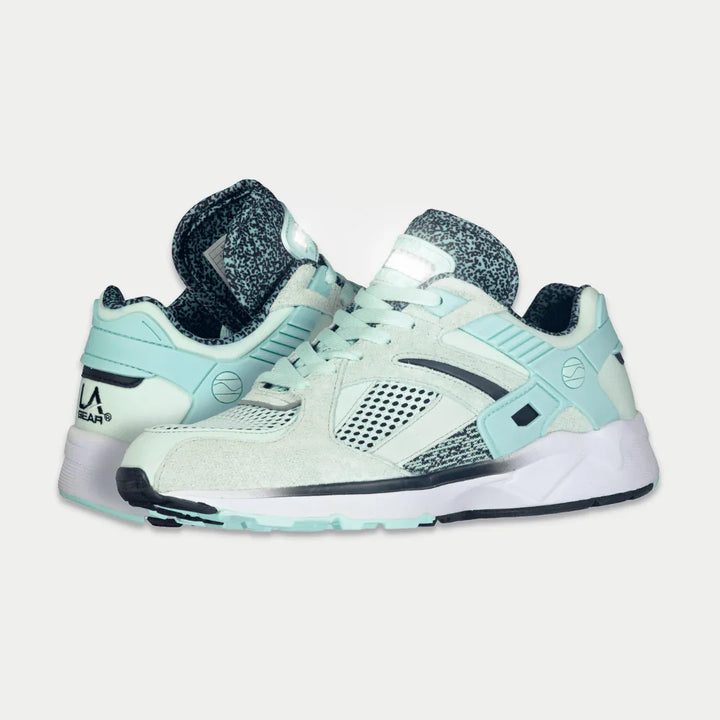 Pair of mint sneakers with black accents on a light gray background