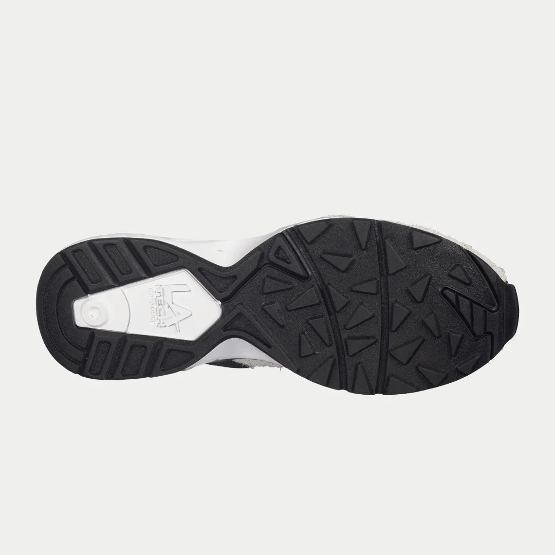 Black and white sole of a sneaker on a light gray background
