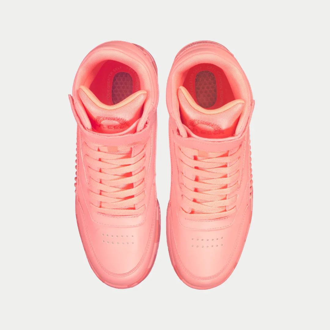 Pair of neon peach sneakers on a light gray background