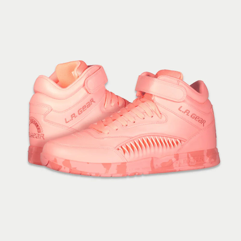 Neon peach glow sneakers with 'L.A. Gear' branding on a light gray background