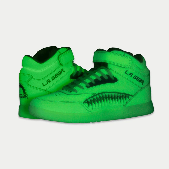 Yellow hightop sneakers with 'LA Gear' branding on a light gray background