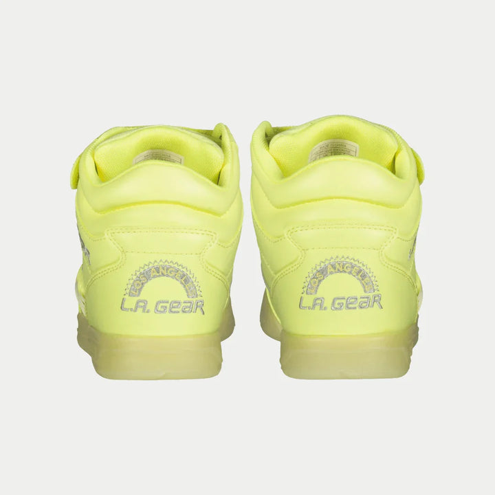 Pair of neon yellow sneakers with 'LA Gear' branding on a light gray background