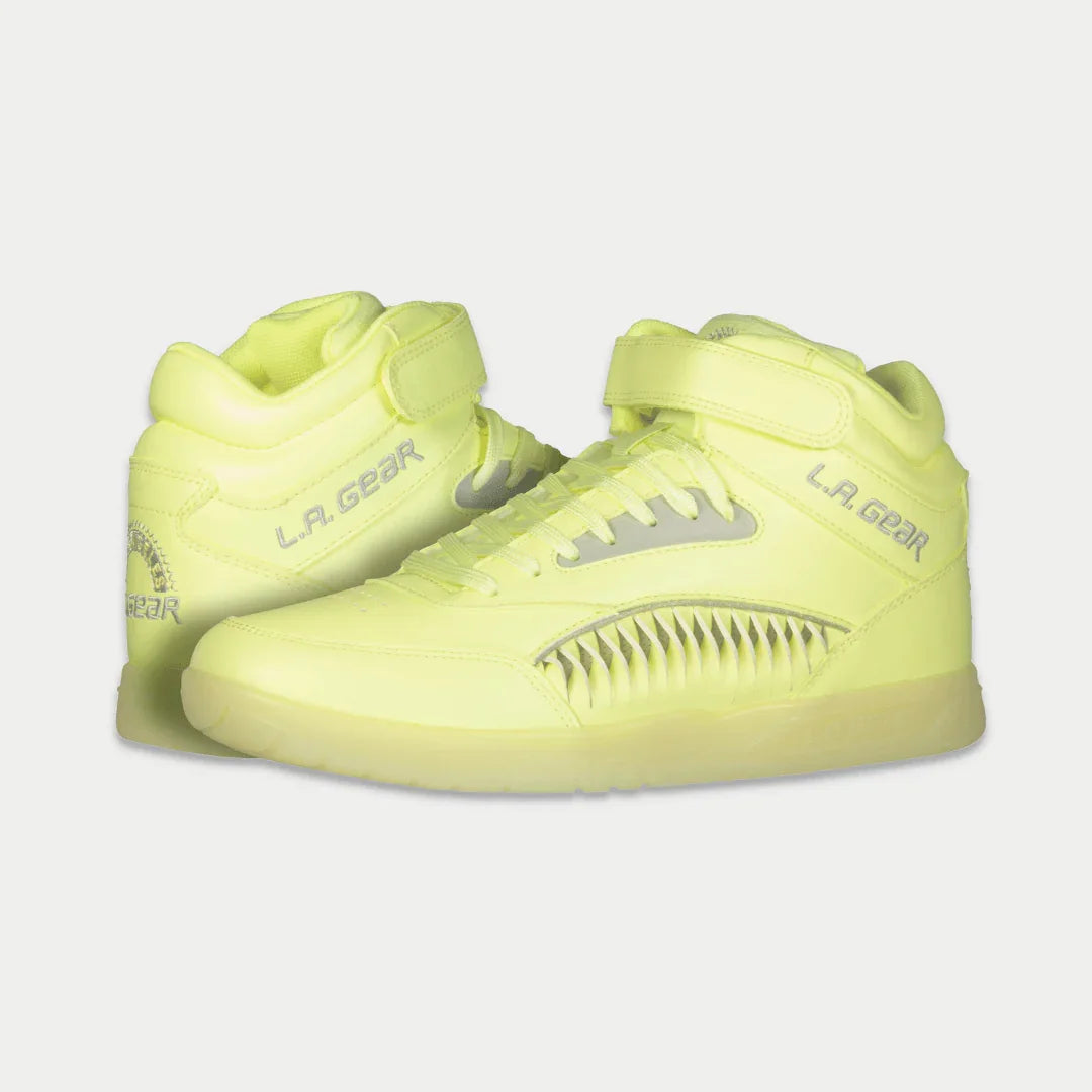 Pair of neon yellow sneakers with 'L.A. Gear' branding on a light gray background