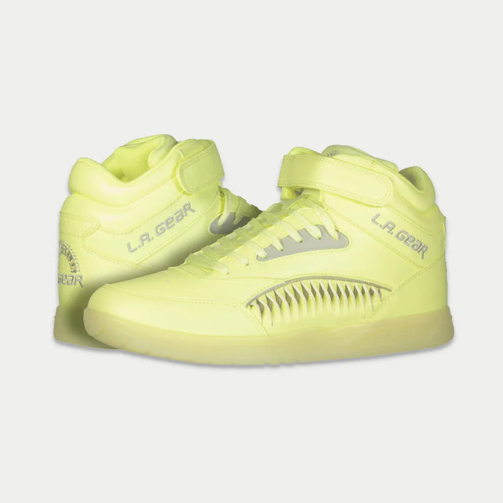 Pair of neon yellow sneakers with 'L.A. Gear' branding on a light gray background