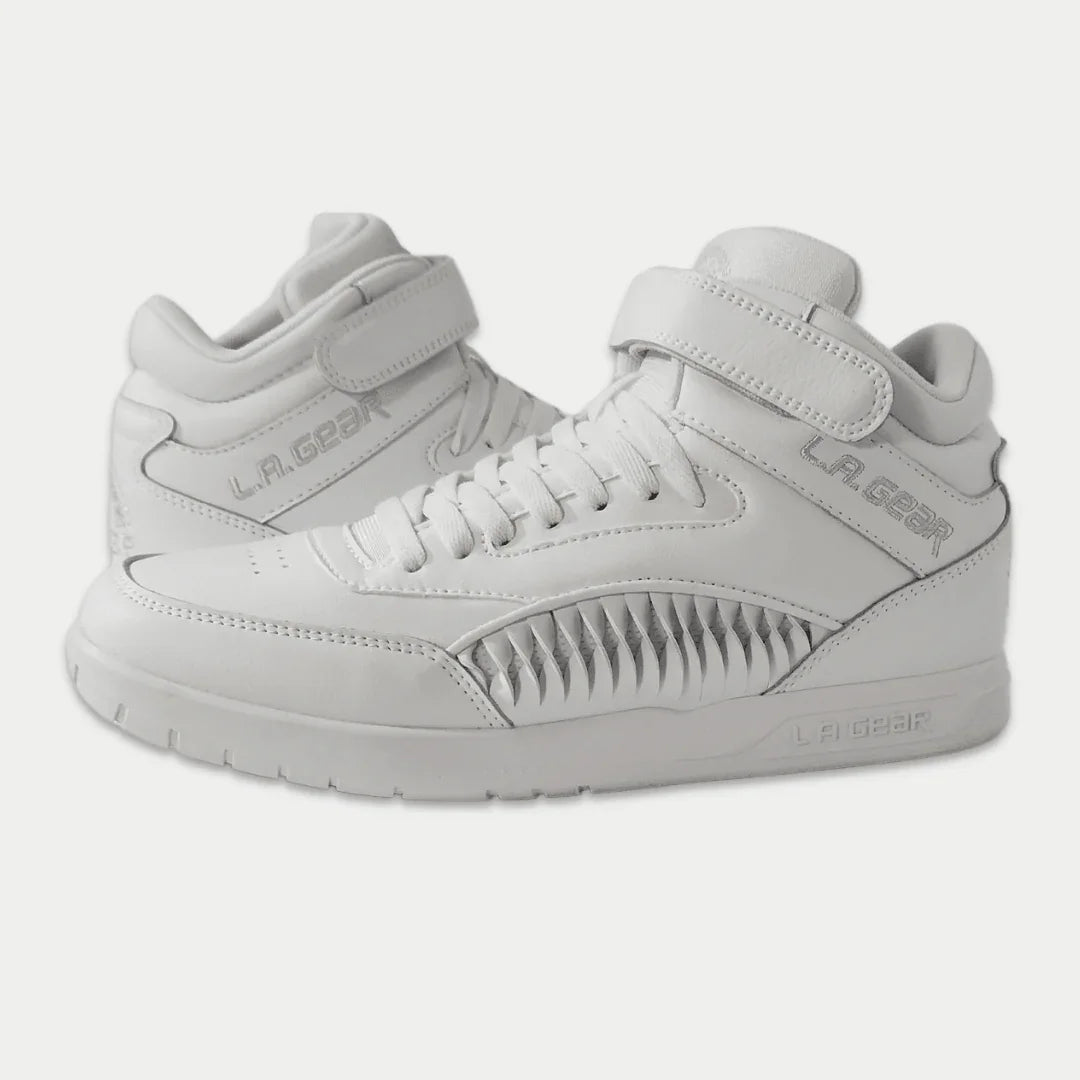 White hightop sneakers with 'L.A. Gear' branding on a light gray background