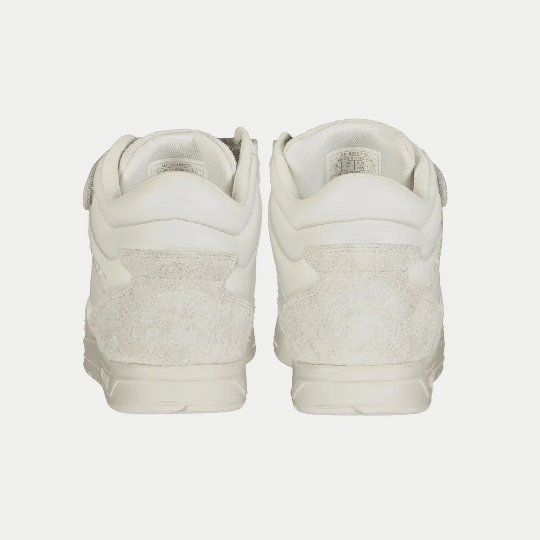 Pair of white sneakers on a light gray background