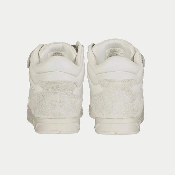 Pair of white sneakers on a light gray background