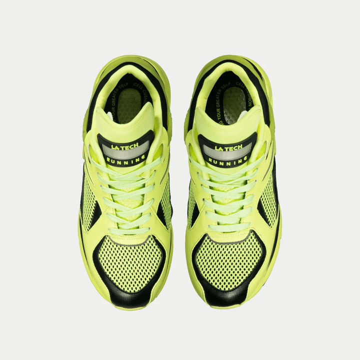 Pair of neon yellow running shoes with black accents on a light gray background